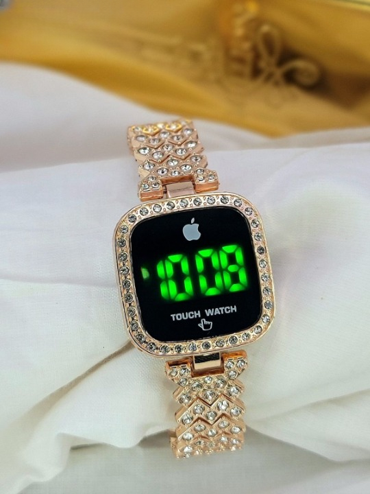 Digital watch with rose gold strap on a white surface