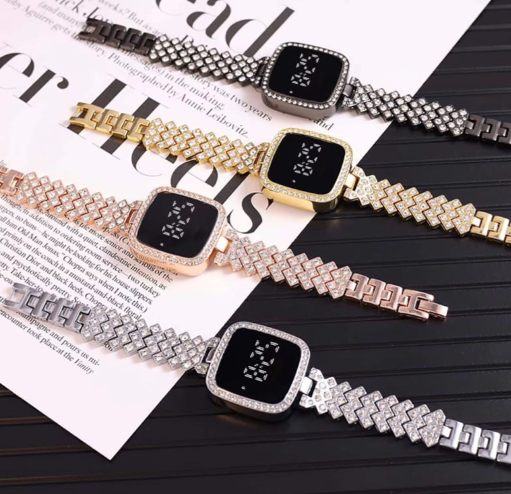 Four smartwatches with diamond-studded bracelets on a magazine page.