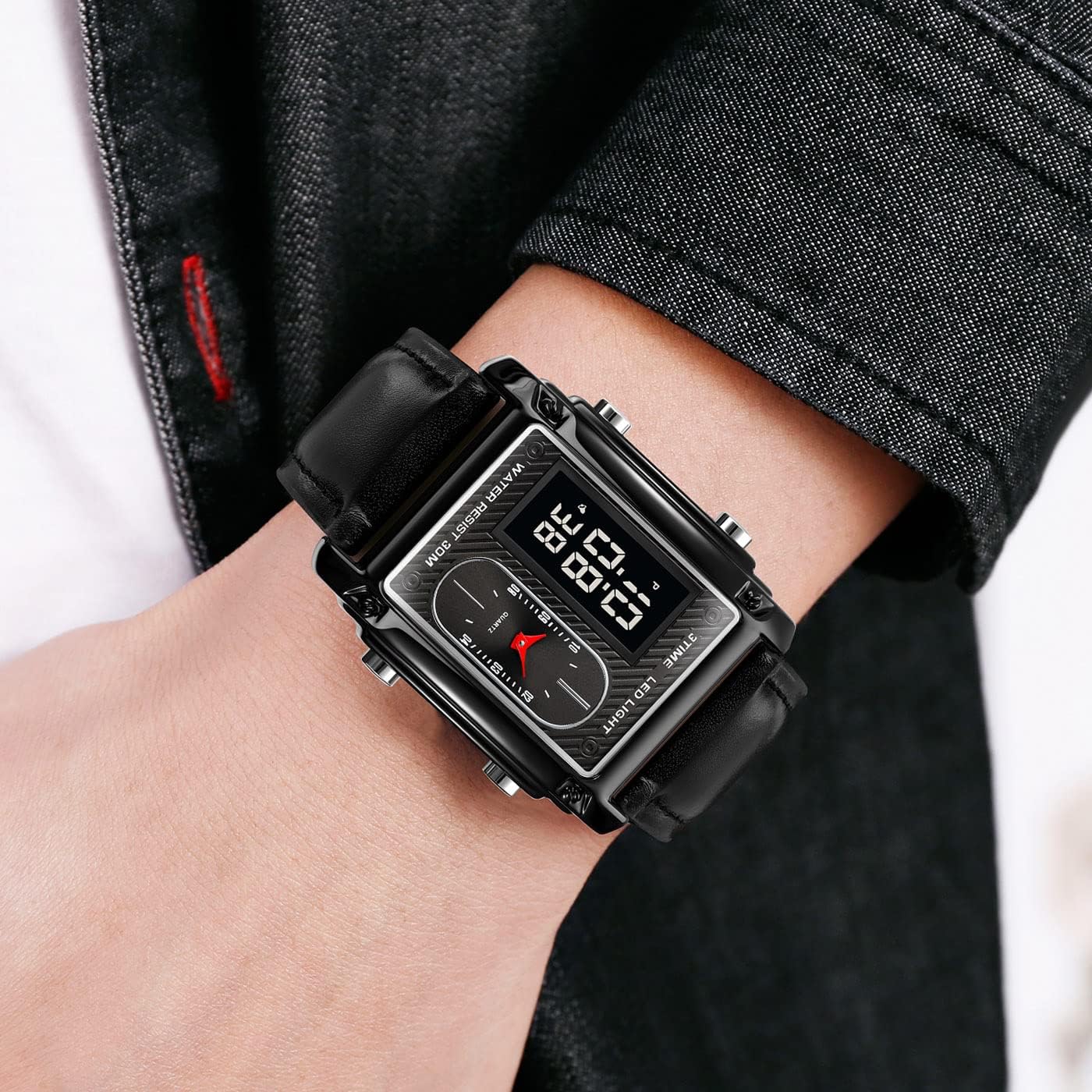 Black digital wristwatch on a person's wrist with a blurred background