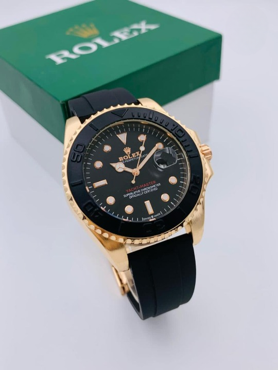 Gold and black watch with a Rolex logo on a white background