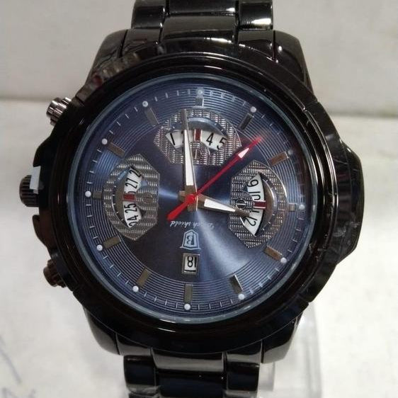 Black wristwatch with a detailed face on a white background