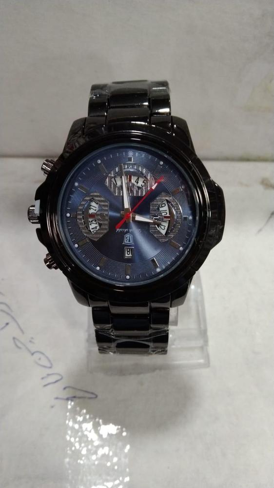 Black wristwatch with a blue face on a white background