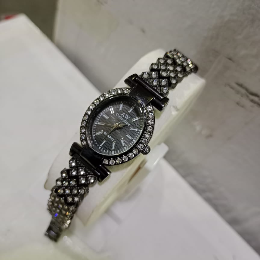 Watch with a decorative black strap on a white surface
