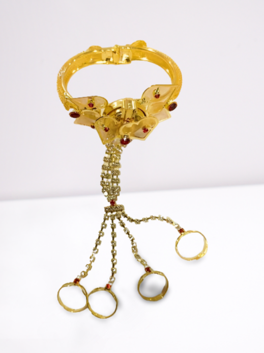Gold bracelet with dangling elements on a white background