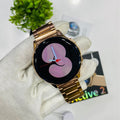 Gold smartwatch on a white cloth with a blurred background