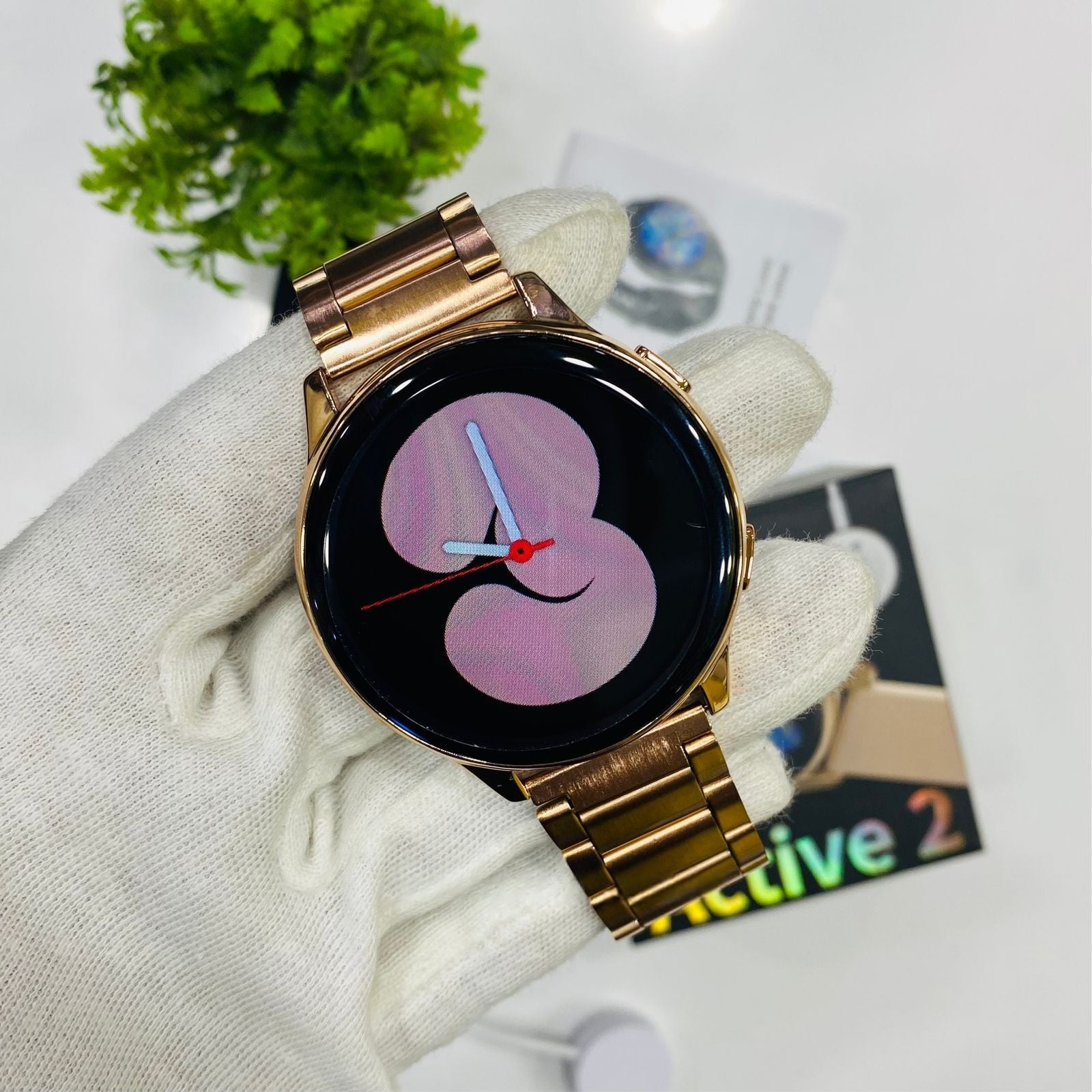 Gold smartwatch on a white cloth with a blurred background